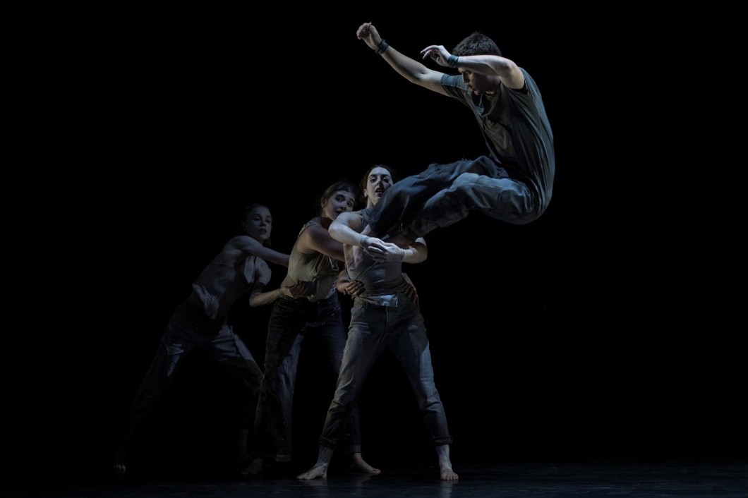 The Circa ensemble performs acrobatics on stage.