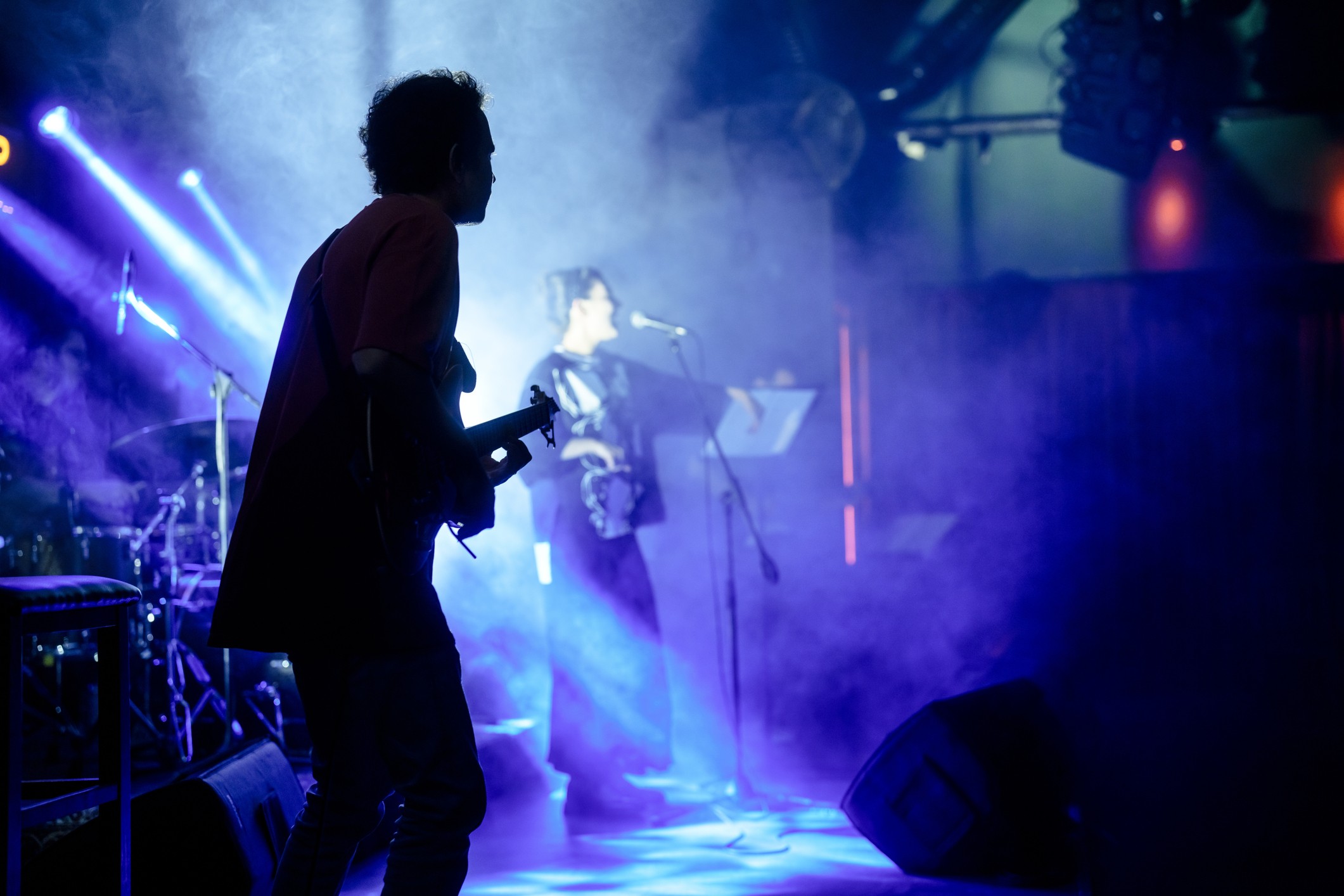 Guitarist and singer performing on stage.