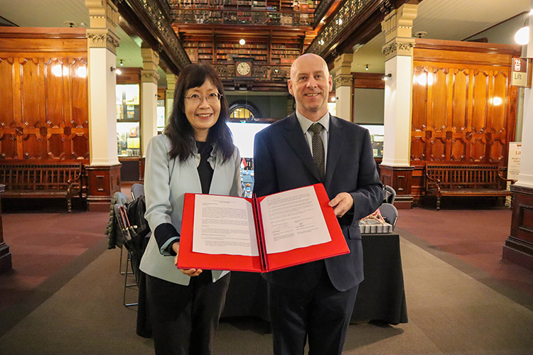 Event-co-convenors-lee-tung-jean-and-phil-smith-holding-the-signed-terms-of-reference-for-the-third-term-of-the-australia-singapore-arts-group.