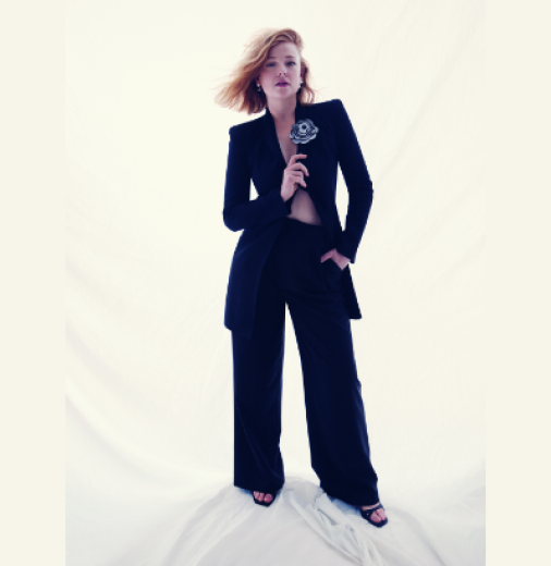 Actor Sarah Snook dressed in black against a white backdrop