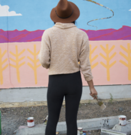 Artist looking at wall art