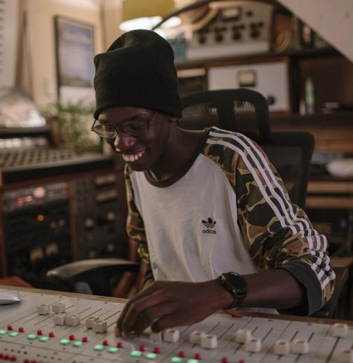 person at an audio mixing table