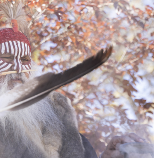 First Nations Elder outdoors holding a feather in the foreground.