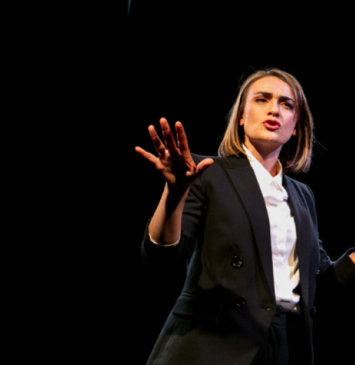 Performer on stage under the bright stage lights. Image supplied by Griffin Theatre Company Limited.