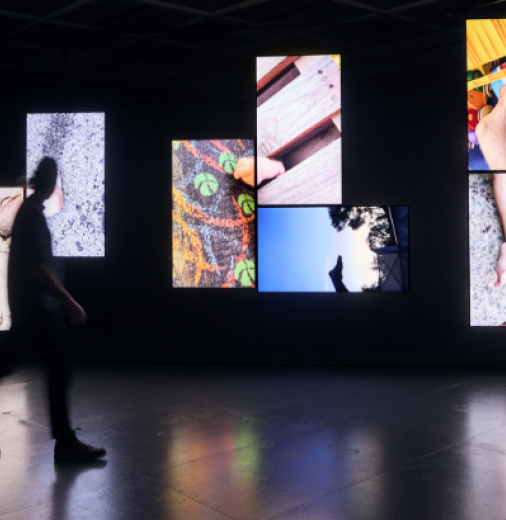 Person walking past Bruno Booth, Body Shots, 2022, video installation.
