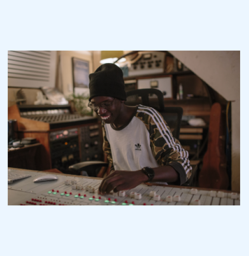 Dut Garang in studio, 2021. Photograph by Stevie Lee Fisher Photography. Dut Garang is working in a music studio, mixing audio.