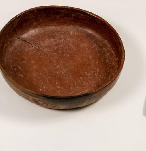 Three cultural objects from Mexico—a ceramic whistle, a ceramic bowl, and 2 green plaques resembling ears. 