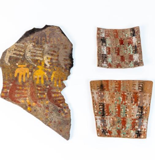 Two ceramic tablets and stone plaque with intricate painted details 
