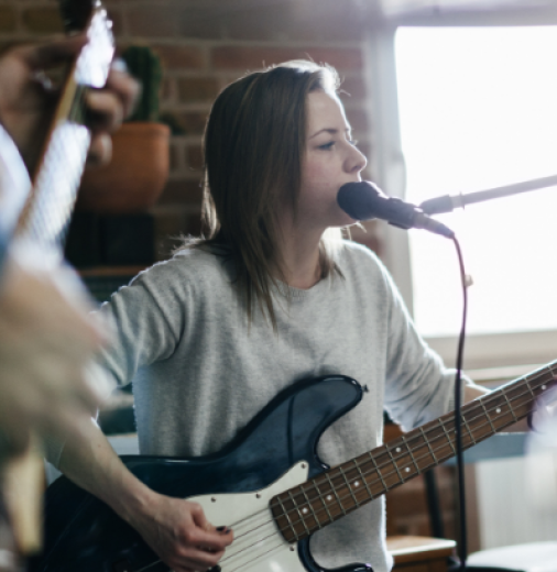 musician playing guitar and singing