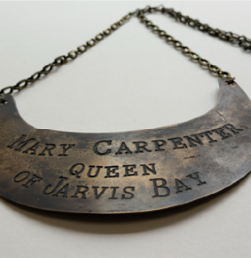 A brass breastplate with inscribed words: Mary Carpenter Queen of Jarvis Bay.