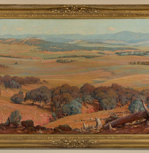  A landscape painting of early Canberra, hanging on a wall in a gold frame.