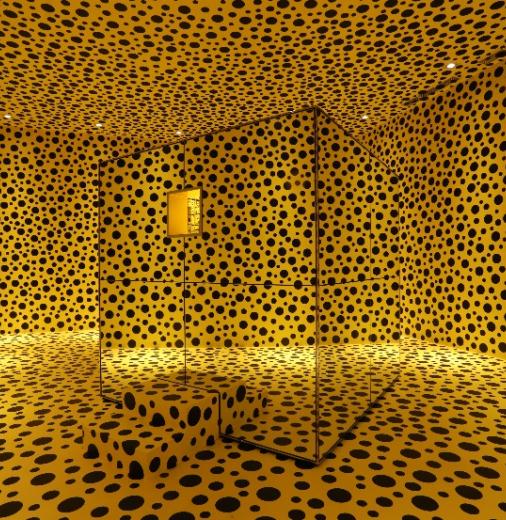 A large room with yellow walls covered in black dots resembling a leopard print pattern.