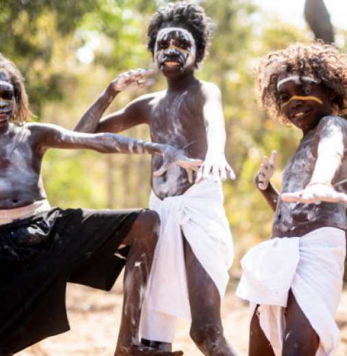 Three young Balkarranga clan members posing outside, ready to perform.
