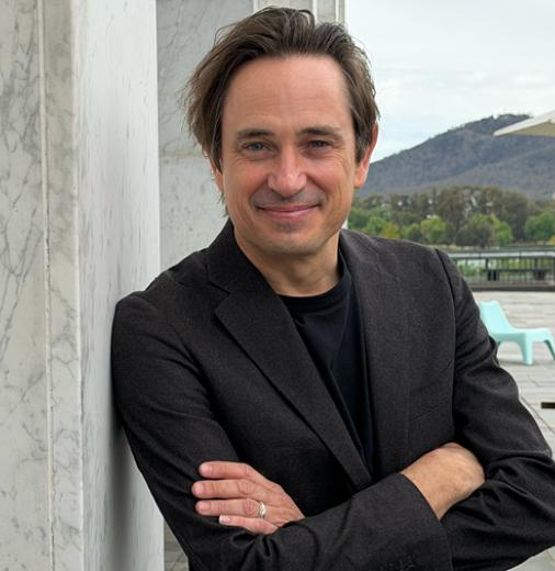 Author Trent Dalton stands outside the National Library of Australia in Canberra.