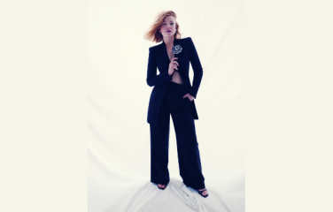 Actor Sarah Snook dressed in black against a white backdrop