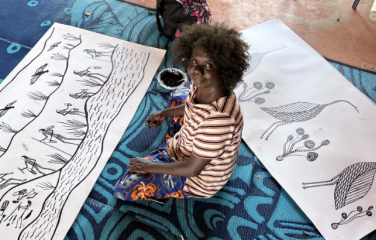 Jay Jurrupula Rostron with two new 2022-2023 screen print designs ‘Galk and Namurre Boko’ during workshop with Bobbie Ruben in 2022 (Bawinanga Aboriginal Corporation).