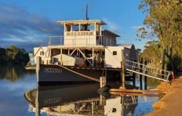 Boat tied up to wharf on water (canal, river).